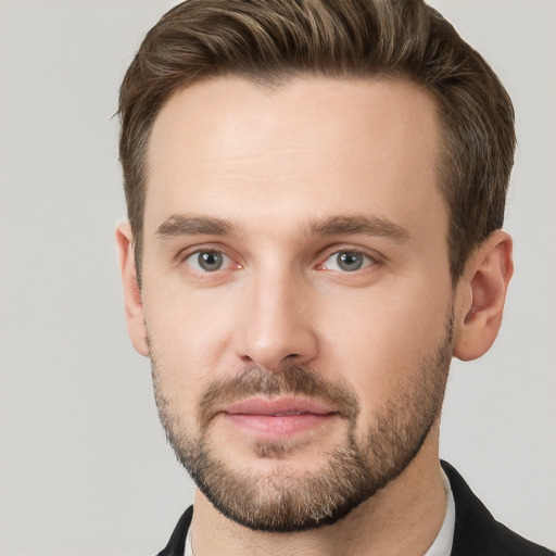 Joyful white young-adult male with short  brown hair and grey eyes