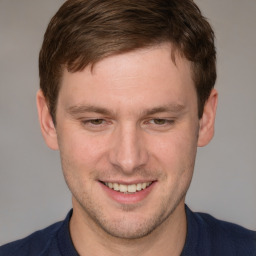 Joyful white adult male with short  brown hair and grey eyes