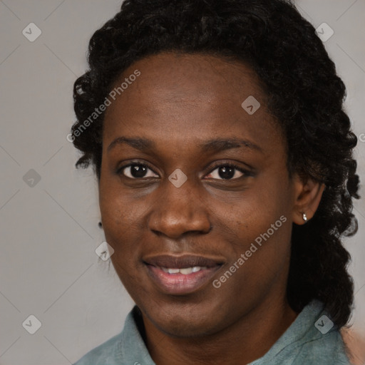 Joyful black young-adult female with long  brown hair and brown eyes