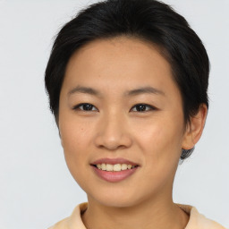 Joyful asian young-adult female with short  brown hair and brown eyes