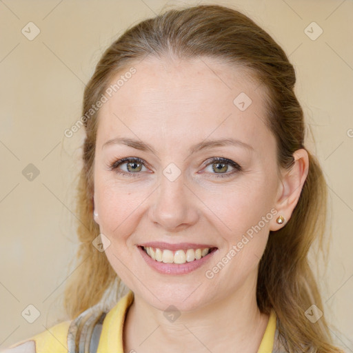 Joyful white young-adult female with medium  brown hair and blue eyes