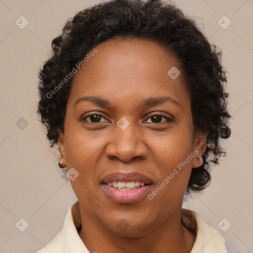 Joyful black adult female with short  brown hair and brown eyes