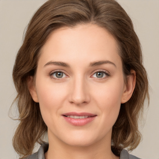 Joyful white young-adult female with medium  brown hair and green eyes