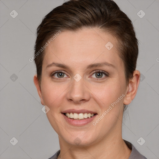 Joyful white young-adult female with short  brown hair and grey eyes