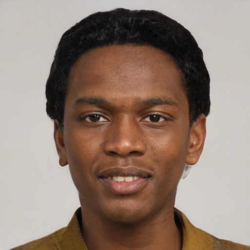 Joyful black young-adult male with short  black hair and brown eyes