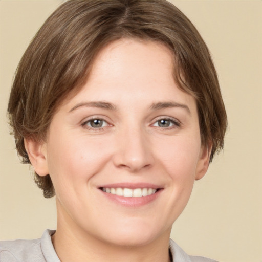 Joyful white young-adult female with medium  brown hair and grey eyes