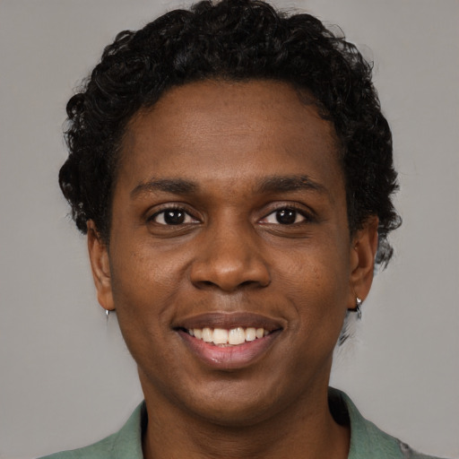 Joyful black young-adult male with short  brown hair and brown eyes