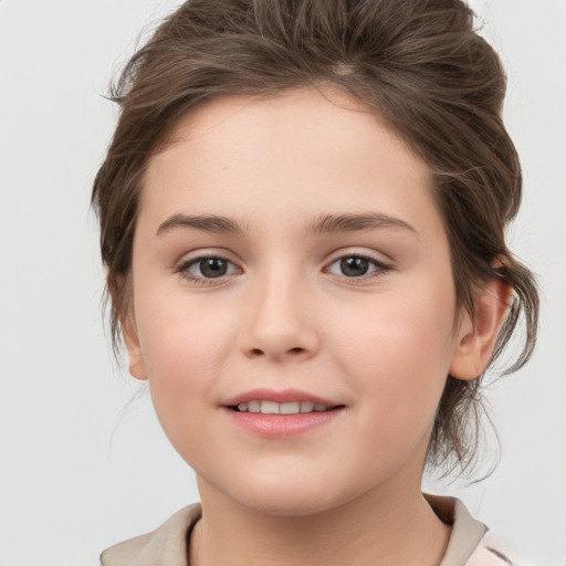 Joyful white child female with medium  brown hair and brown eyes