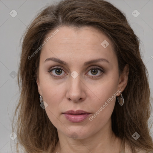 Joyful white adult female with long  brown hair and grey eyes