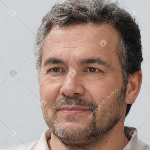 Joyful white adult male with short  brown hair and brown eyes