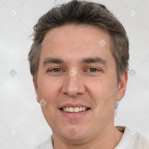 Joyful white adult male with short  brown hair and brown eyes