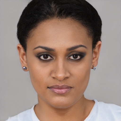 Joyful latino young-adult female with short  brown hair and brown eyes