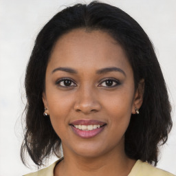 Joyful black young-adult female with medium  brown hair and brown eyes