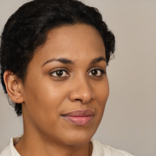 Joyful black young-adult female with short  brown hair and brown eyes