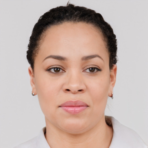 Joyful black young-adult female with short  brown hair and brown eyes