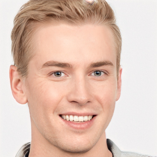 Joyful white young-adult male with short  brown hair and blue eyes