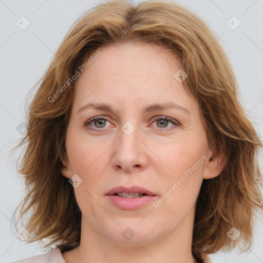 Joyful white adult female with medium  brown hair and blue eyes