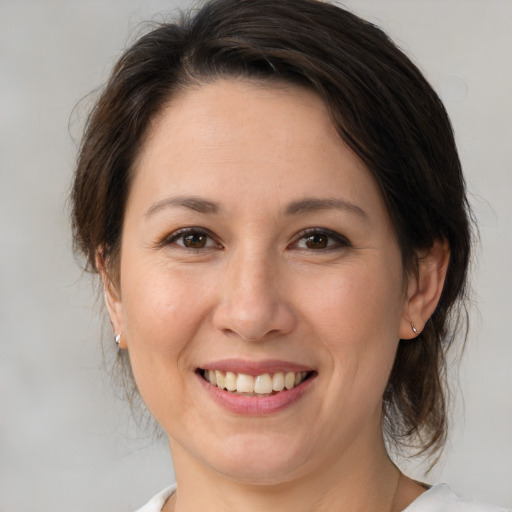 Joyful white young-adult female with medium  brown hair and brown eyes