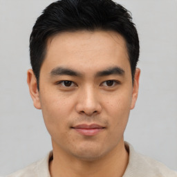 Joyful asian young-adult male with short  black hair and brown eyes