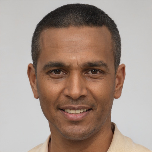 Joyful latino adult male with short  black hair and brown eyes