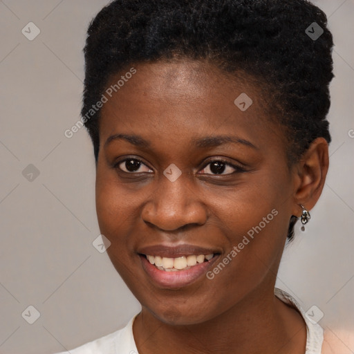 Joyful black young-adult female with short  brown hair and brown eyes