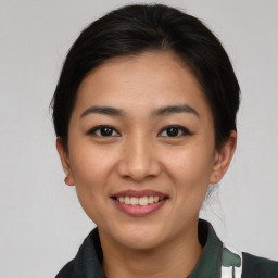 Joyful asian young-adult female with short  brown hair and brown eyes