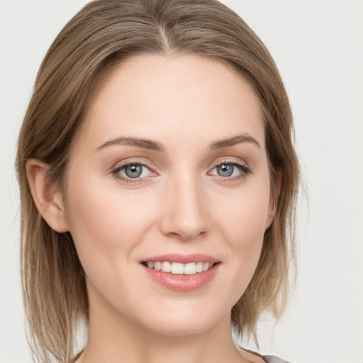 Joyful white young-adult female with medium  brown hair and blue eyes