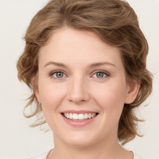 Joyful white young-adult female with medium  brown hair and green eyes