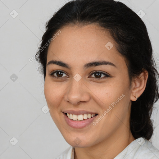 Joyful latino young-adult female with medium  brown hair and brown eyes