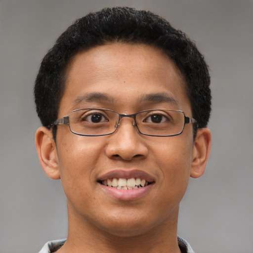 Joyful latino young-adult male with short  brown hair and brown eyes