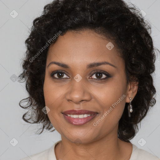 Joyful black young-adult female with long  brown hair and brown eyes