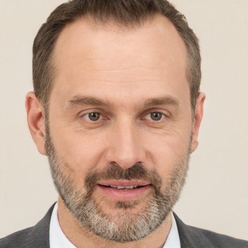 Joyful white adult male with short  brown hair and brown eyes