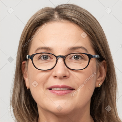 Joyful white adult female with long  brown hair and grey eyes