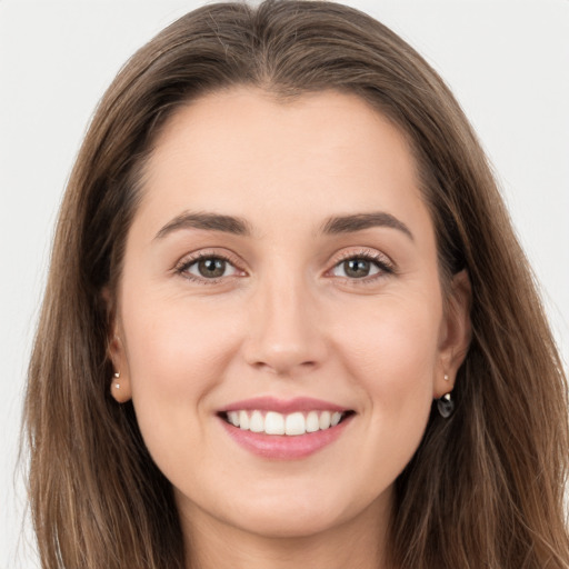 Joyful white young-adult female with long  brown hair and brown eyes