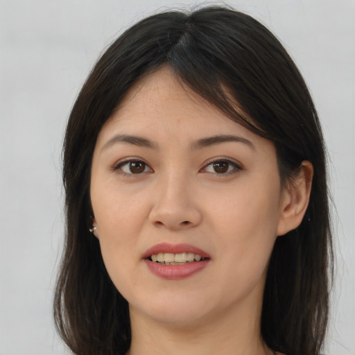 Joyful asian young-adult female with long  brown hair and brown eyes