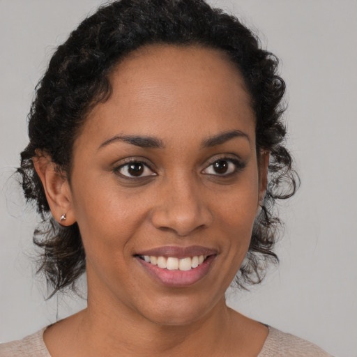 Joyful latino young-adult female with short  brown hair and brown eyes