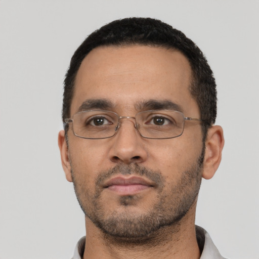 Neutral latino adult male with short  black hair and brown eyes