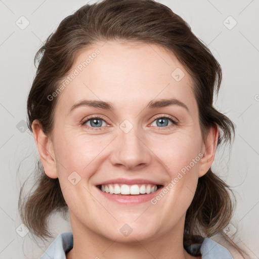 Joyful white young-adult female with medium  brown hair and blue eyes