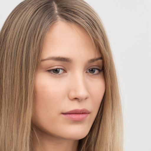 Neutral white young-adult female with long  brown hair and brown eyes