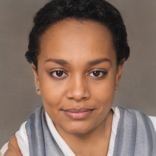 Joyful black young-adult female with short  black hair and brown eyes