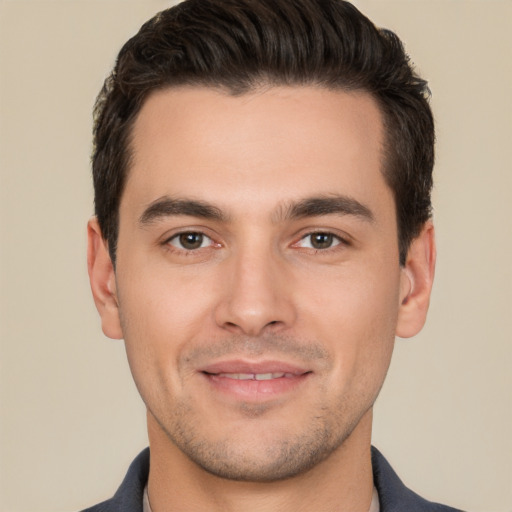 Joyful white young-adult male with short  brown hair and brown eyes