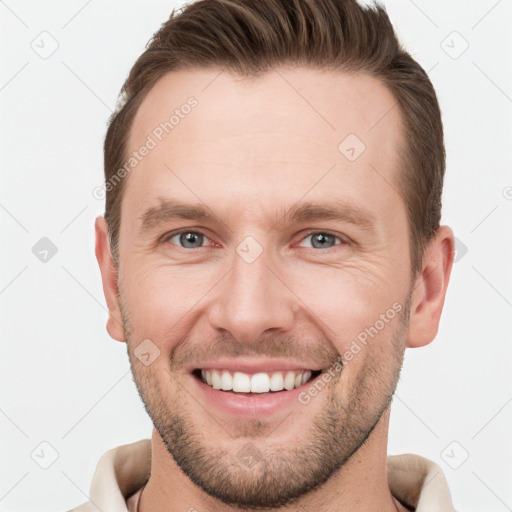 Joyful white young-adult male with short  brown hair and grey eyes