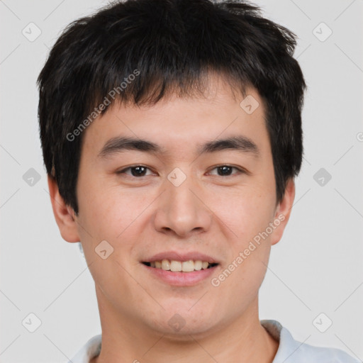 Joyful asian young-adult male with short  brown hair and brown eyes