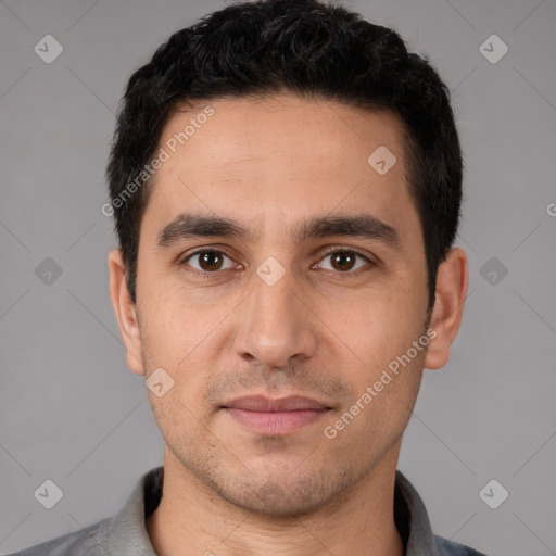 Joyful white young-adult male with short  black hair and brown eyes