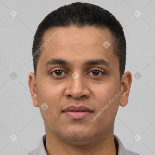 Joyful latino young-adult male with short  brown hair and brown eyes