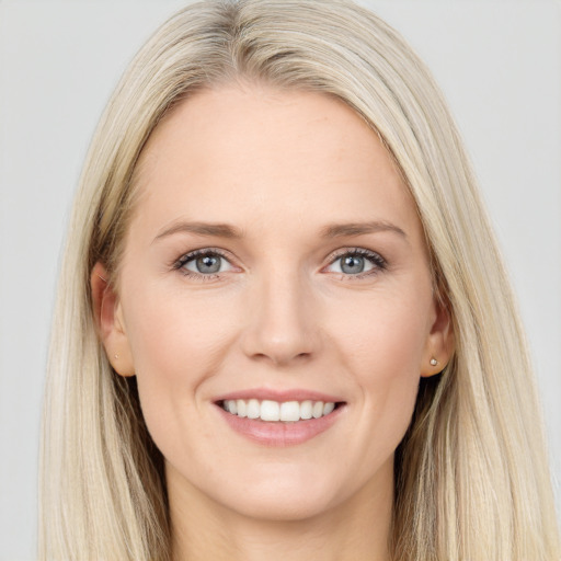 Joyful white young-adult female with long  brown hair and blue eyes