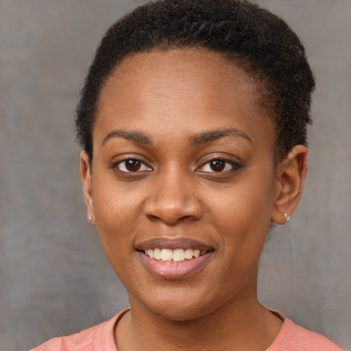 Joyful black young-adult female with short  brown hair and brown eyes