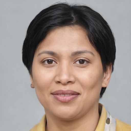 Joyful asian adult female with medium  brown hair and brown eyes