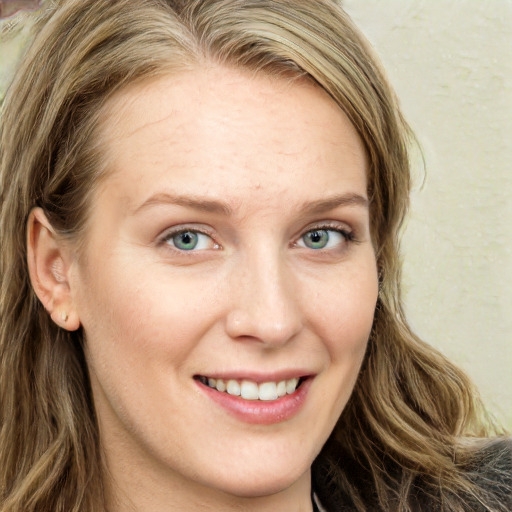 Joyful white young-adult female with long  brown hair and blue eyes