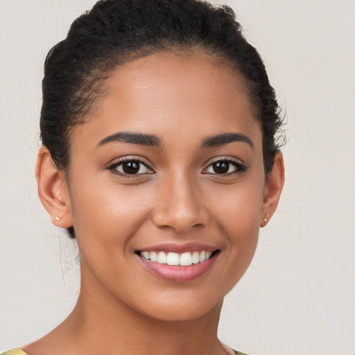 Joyful latino young-adult female with short  brown hair and brown eyes